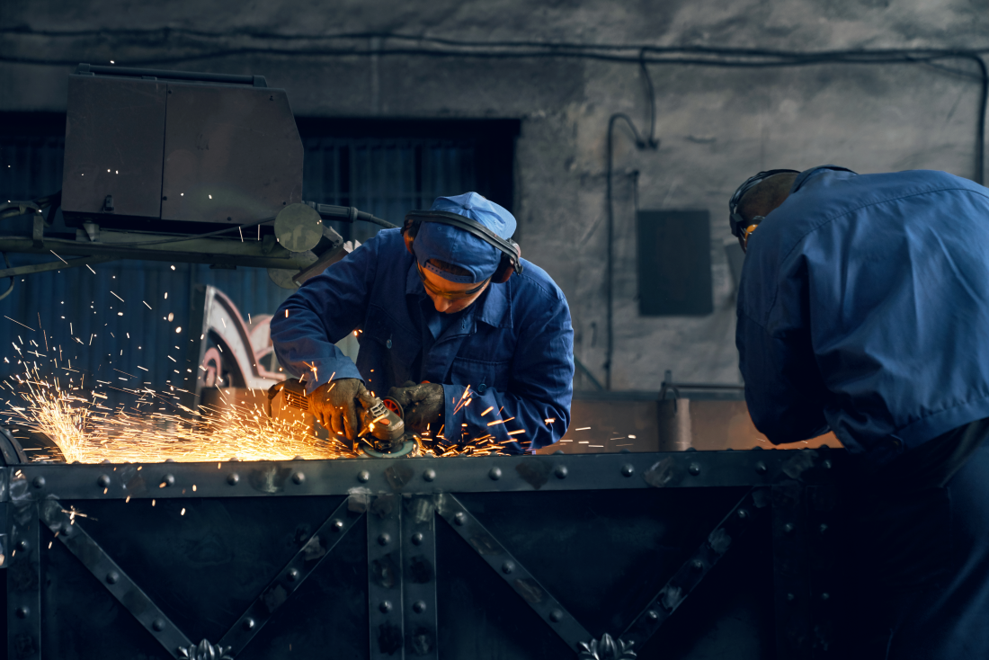 Two workers fabricating steel gates at Sagar Steel factory